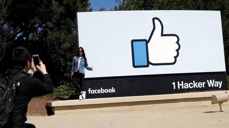 This file photo shows visitors take photos in front of the Facebook logo at the companys headquarters in Menlo Park, Calif. (Photo: AP)
