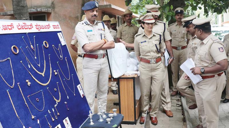 Police officials inspects recovered jewles during  property parade in Bengaluru on Monday (Photo: DC)