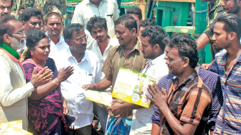 BJP state president Dr Tamilisai Soundararajan  accompanies party candidate Gangai Amaran in canvassing for votes among fishermen at Kasimedu in R. K. Nagar Assembly constituency on Sunday (Photo: DC)