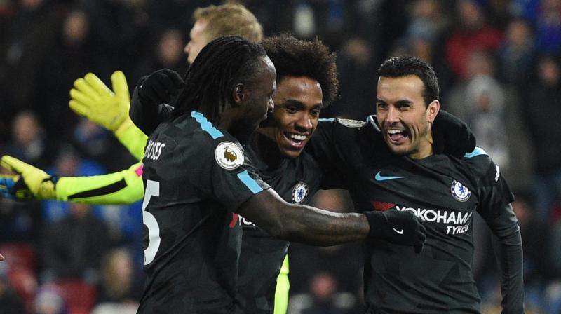 Willian (centre) recalled to the team with striker Alvaro Morata out injured, set up the opening goal by Tiemoue Bakayoko in the 23rd minute and headed in the second in the 43rd. The Brazilian winger laid the ball off for Pedro Rodriguez to score the third in the 50th minute as Chelsea cut through Huddersfield at will. (Photo:AP)