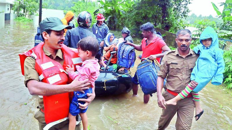 Fire and rescue personnel evacuate residents of Muppathadam near Eloor in Kochi on Wednesday (Photo: ARUN CHANDRABOSE)