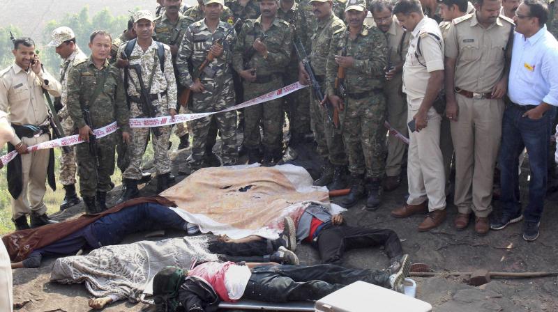 Police at the encounter site at the hillocks of Acharpura village after the STF killed 8 Students of Islamic Movement of India (SIMI) activists who escaped Central Jail killing a security guard in Bhopal. (Photo: PTI)
