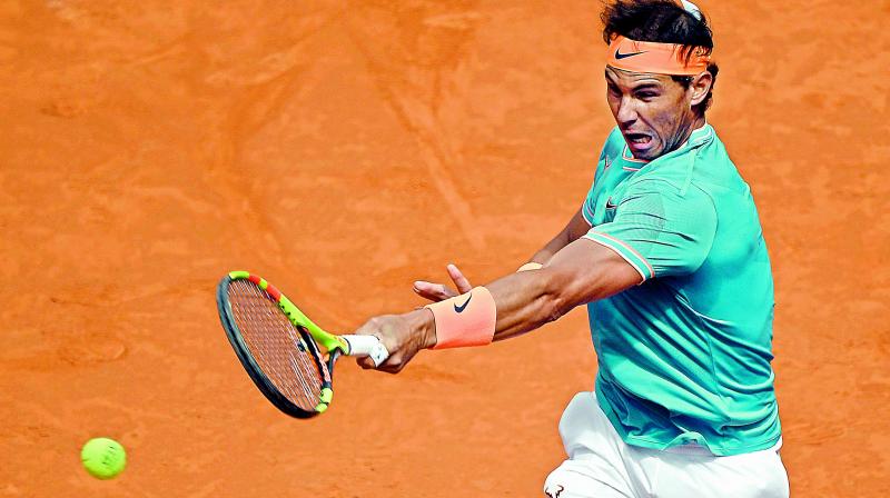 Spains Rafael Nadal returns the ball to Canadas Felix Auger Aliassime during their ATP Madrid Open Round of 32 tennis match at the Caja Magica in Madrid on Thursday. Nadal won 6-3, 6-3. (Photo: AFP)