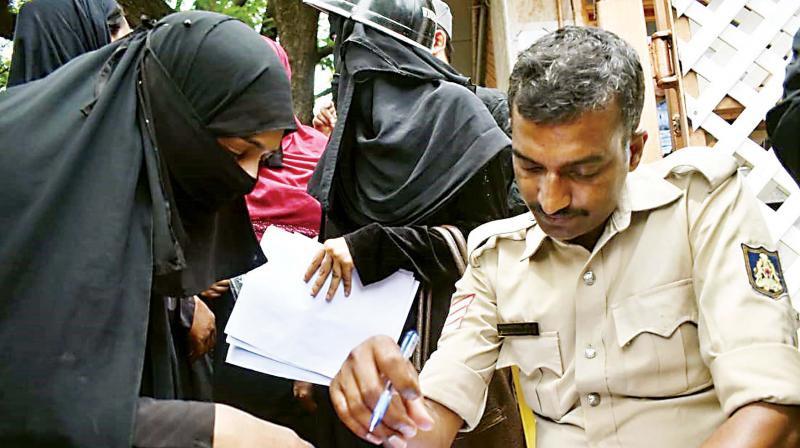 A victim filing a complaint with the police at the IMA office in Shivajinagar on Tuesday (Photo: DC)