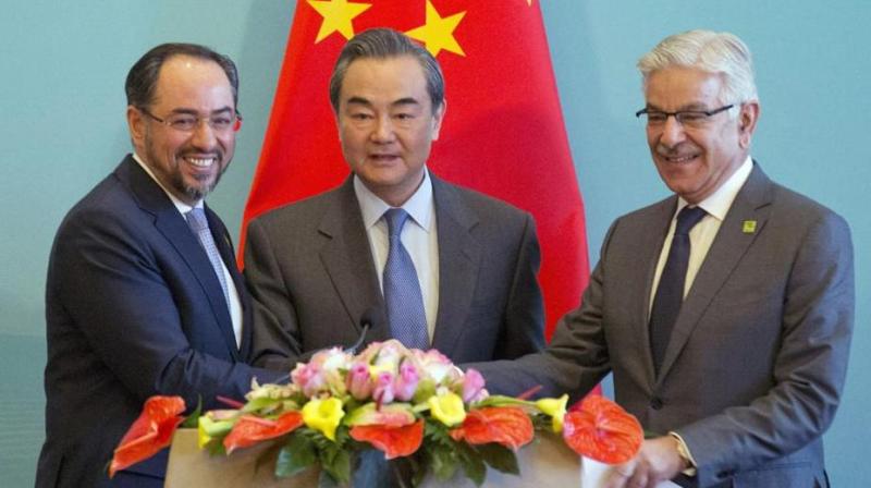 At the first trilateral meeting of Salahuddin Rabbani, Chinese FMâ€‰Wang Yi and Pakistani FMâ€‰Khawaja Asif  on Tuesday, China offered to extend CPEC to Afghanistan as the three sides pledged to step-up counter terrorism cooperation. (Photo: AP)