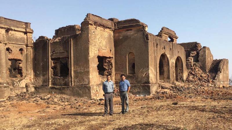 Takat Singh Ranawat, Deputy Conservator of Forests, and S.K. Arun, honorary wildlife warden, in front of the dilapidated Collectors Bungalow atop the Mincheri Hill.  (Photo: DC)