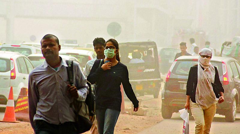Face masks have became a norm for Delhi residents as they commute through the smog-filled streets of Delhi on Monday.  (Photo: PTI)