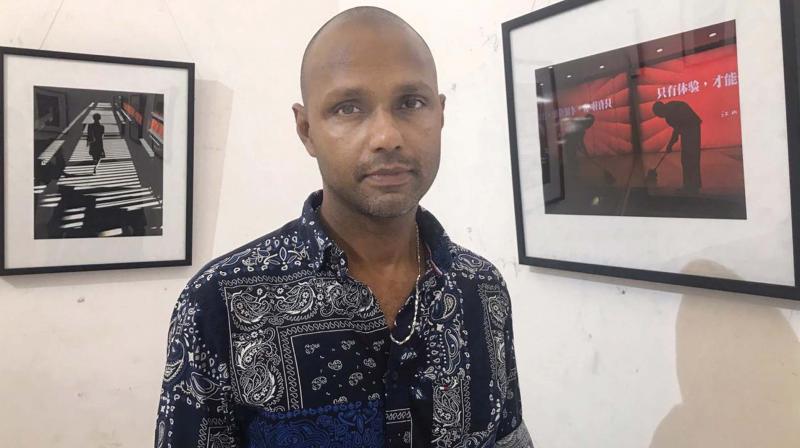 Sudheer Uralath with his photos at the art gallery of Lalithakala Akademi in Thrissur.