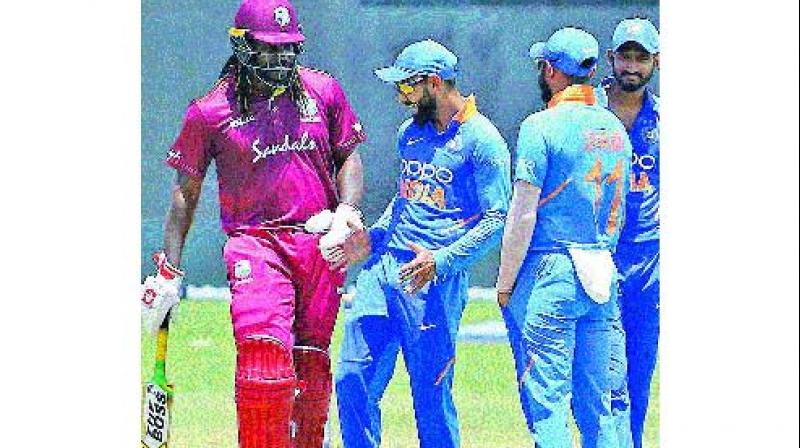 Virat Kohli shakes a leg with Chris Gayle during first ODI which was abandoned due to rain. (Photo: BCCI)