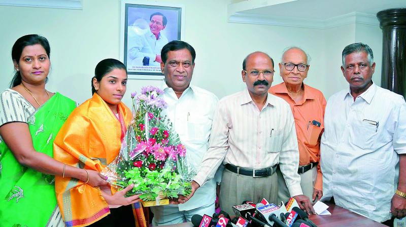 Gymnast Aruna Reddy is felicitated by Sports Authority of Telangana State chairman Allipuram Venkateshwar Reddy (centre) and Vice-chairman & Managing Director A. Dinakar Babu on Saturday.