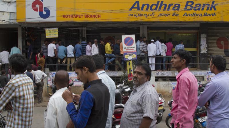 People stand in a queue outside an ATM to withdraw money in Hyderabad. (Photo: AP)