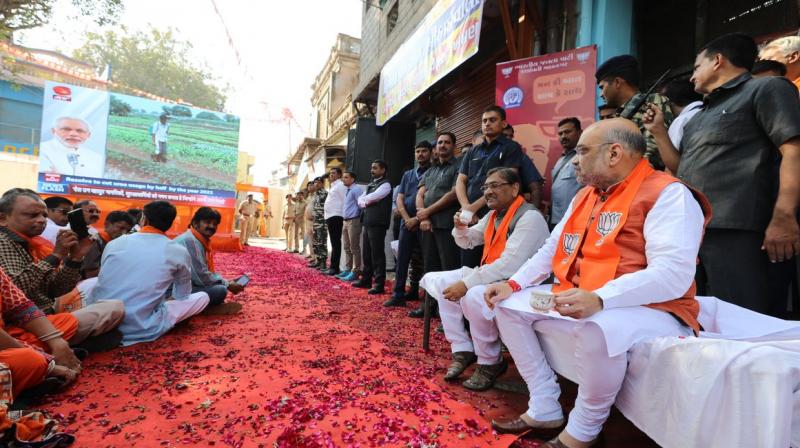 BJP president Amit Shah listened to the programme at a tea stall in the citys Muslim-dominated Dariyapur area in the presence of hundreds of locals and party workers. (Photo: Twitter/Amit Shah)