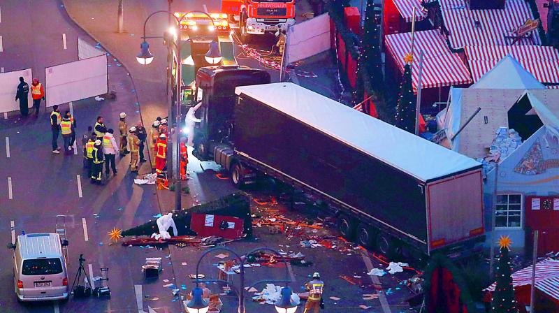 Forensic experts examine the scene around a truck that crashed into a Christmas market in Berlin on Tuesday. 	(Photo: AFP)