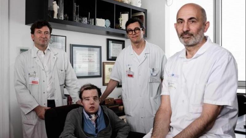 French medicine professor Laurent Lantieri (right), a specialist in hand and face transplant, poses with members of his team and his patient Jerome Hamon on April 13, 2018 at the Hopital Europeen Georges-Pompidou in Paris. (Photo: AFP)