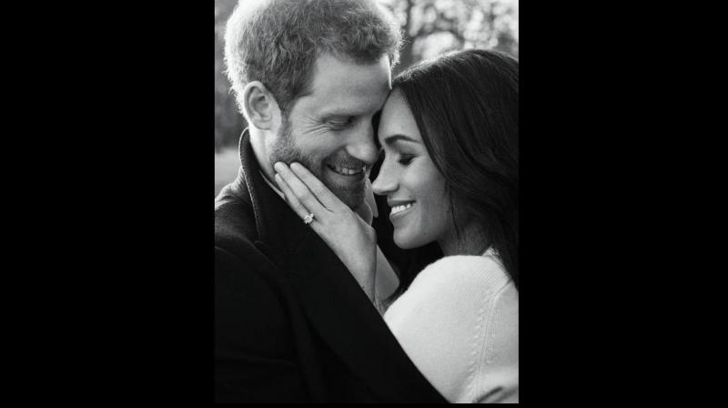 In this photo released by Kensington Palace on Thursday, Dec. 21, 2017, Britains Prince Harry and Meghan Markle pose for one of two official engagement photos, at Frogmore House, in Windsor, England. (Alexi Lubomirski/ AP)