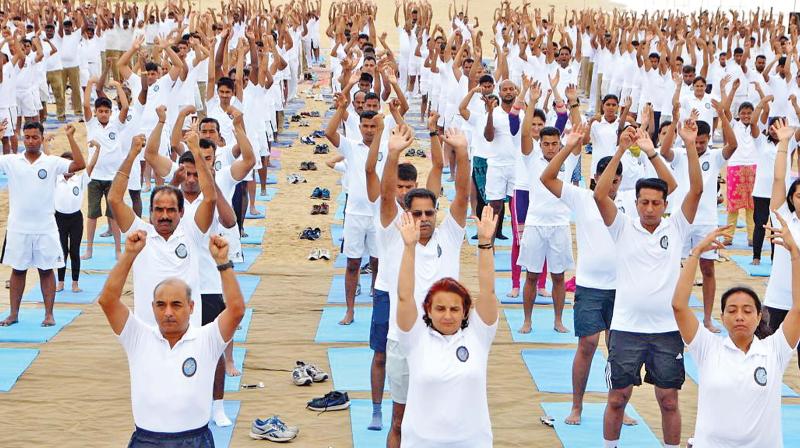 Rear Admiral Alok Bhatnagar, Flag Officer Commanding Tamil Nadu and Puducherry Naval Area, Anand Mohan, Inspector General, CISF South Sector and officers at International Yoga Day event at Marina beach, on Thursday. (Photo: DC)