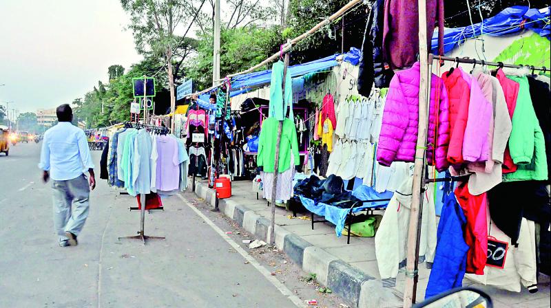 Footpath encroachments have gone a step ahead to occupy the road too at the government printing press in Chanchalguda on Friday.(Photo: P. Surendra)