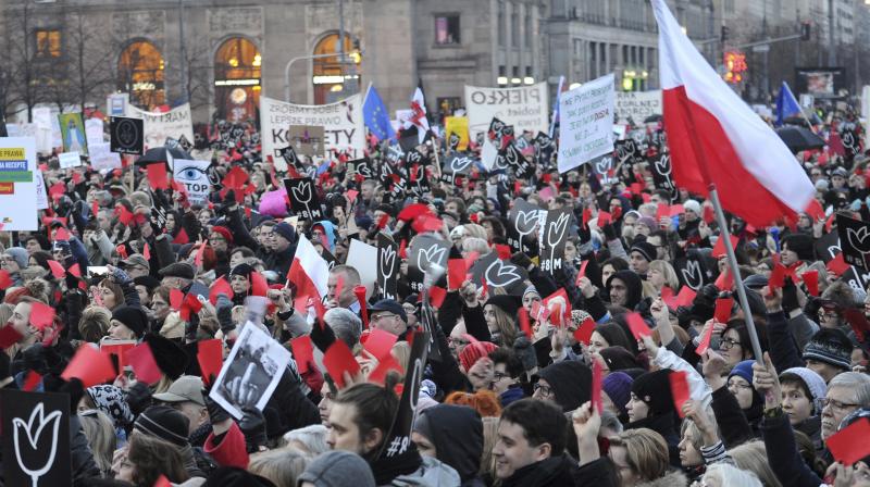 Protesters show the government red cards during a nationwide rally on International Womens Day, in Warsaw, Poland. (Photo: AP)