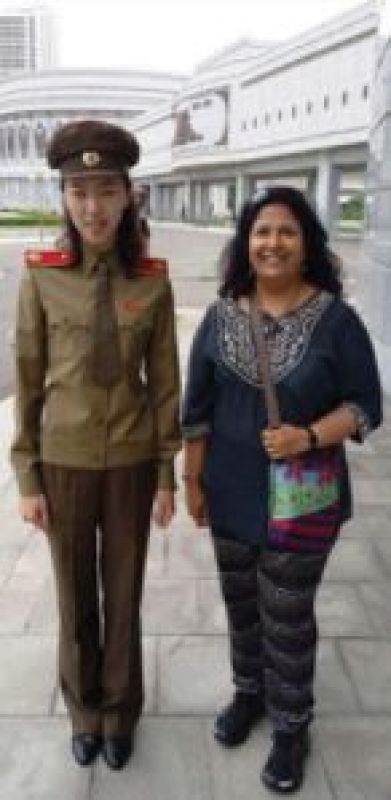 Vibha Jain with a police woman in  North Korea
