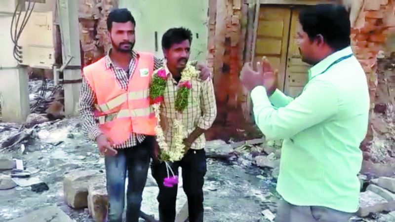 A man is garlanded by a GHMC staffer even as he zips up after urinating in the open in the city on Sunday. 