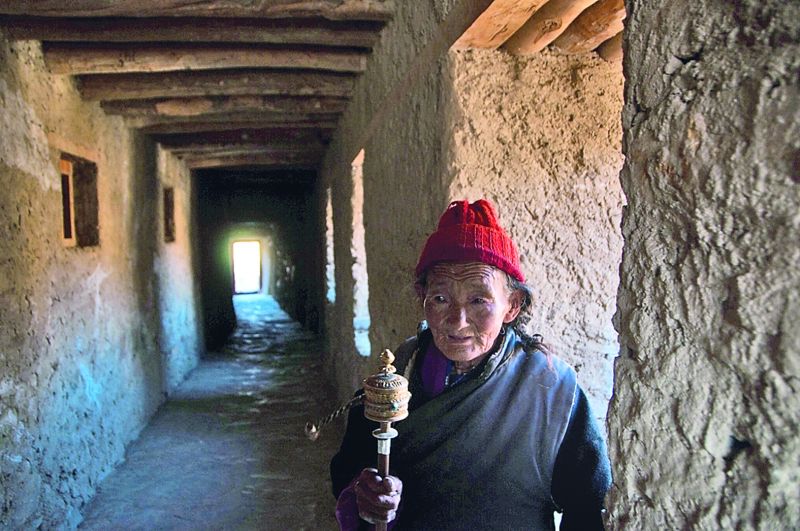 Older people from the region carry prayer sticks and keep chanting. This image was shot at Lamayaru Monastery, Ladakh