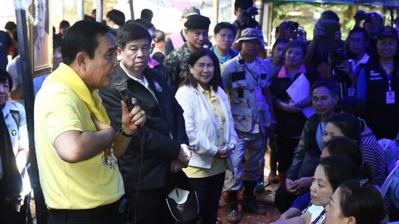 Thai Prime Minister Prayut Chan-O-Cha (L) speaks to family members of missing children and their coach camping out at Khun Nam Nang Non Forest Park in Chiang Rai province on June 29, 2018. (Photo: AFP)