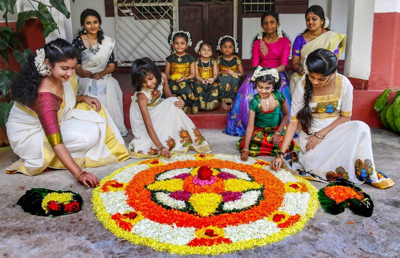  Girls prepare flower carpet (Onappookkalam) on Onam in Kannur. (Photo: PTI)