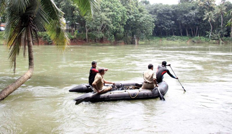 Fire and Rescue personnel search for Dinu Alex (L) who went missing in Meenachil  River at Aarumanoor in Kottayam on Friday. (Photo: Rajeev Prasad)