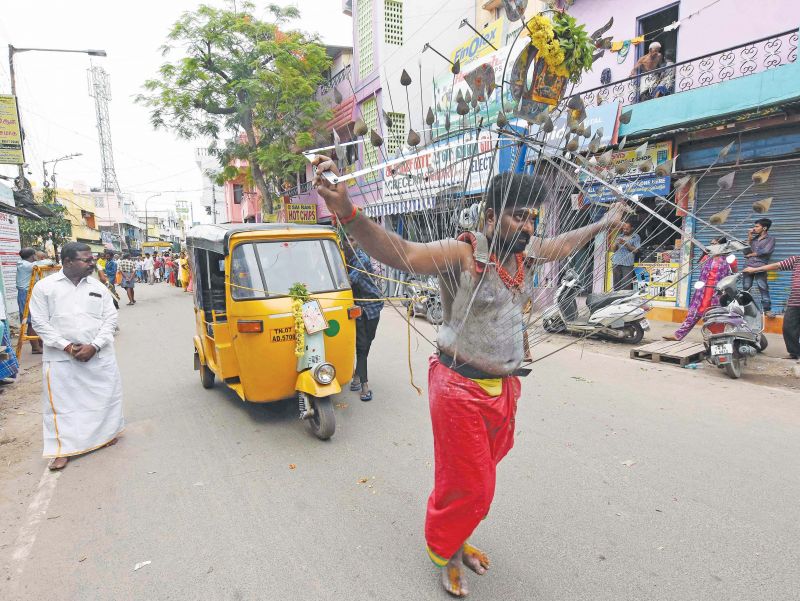 A body pierced  devotee in Thulukanathamman temple in Triplicane pulls an auto as part of Aadi festivities. (Photo: DC)