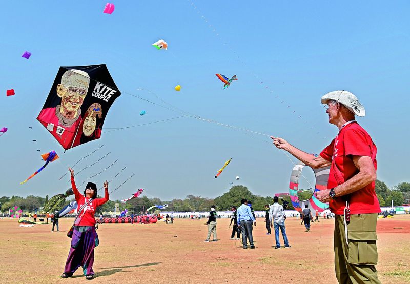 An old couple flying a kite with their photos printed on it at the Kite Festival at Parade Ground on Sunday. (Photo:DC)