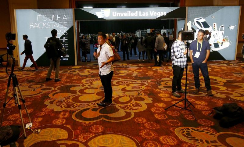 Television reporters do their live standup segments from the entrance at the CES Unveiled at CES International Sunday, Jan. 6, 2019, in Las Vegas. (AP Photo/Ross D. Franklin)