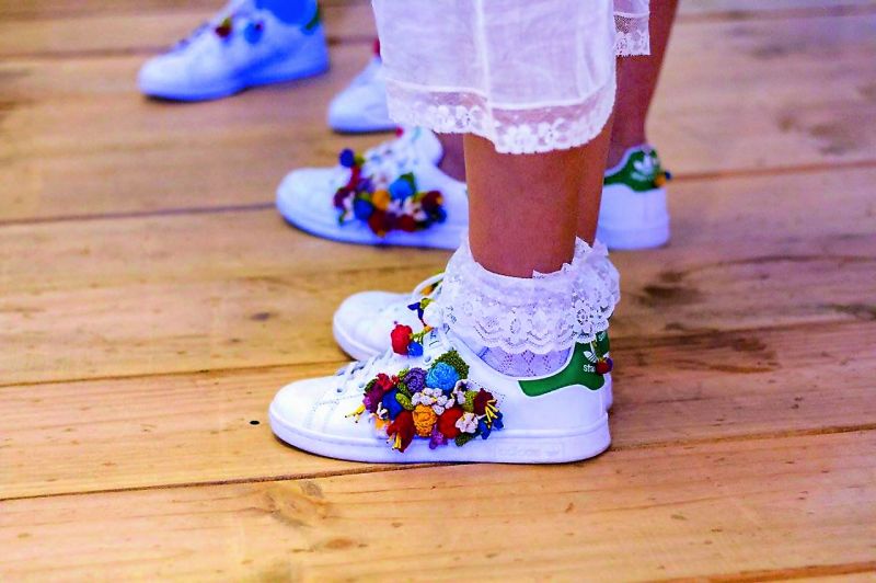 Aneeth Arora worked with Afghan refugees to hand crochet flowers on tennis shoes