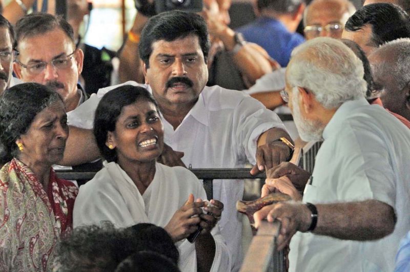 Prime Minister Narendra Modi listens to the woes of a woman during his visit at Poonthura in Thiruvananthapuram