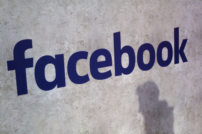 FILE - This Jan. 17, 2017, file photo shows a Facebook logo being displayed in a start-up companies gathering at Paris' Station F, in Paris. Facebook is taking baby steps for now to address the latest privacy scandal after news broke Friday, March 16, 2018, that Cambridge Analytica may have used data improperly obtained from roughly 50 million Facebook users to try to sway elections. (AP Photo/Thibault Camus, File)