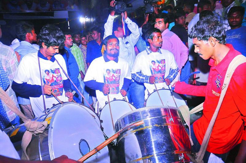 Fans celebrate by playing drums before the premiere show in Hyderabad