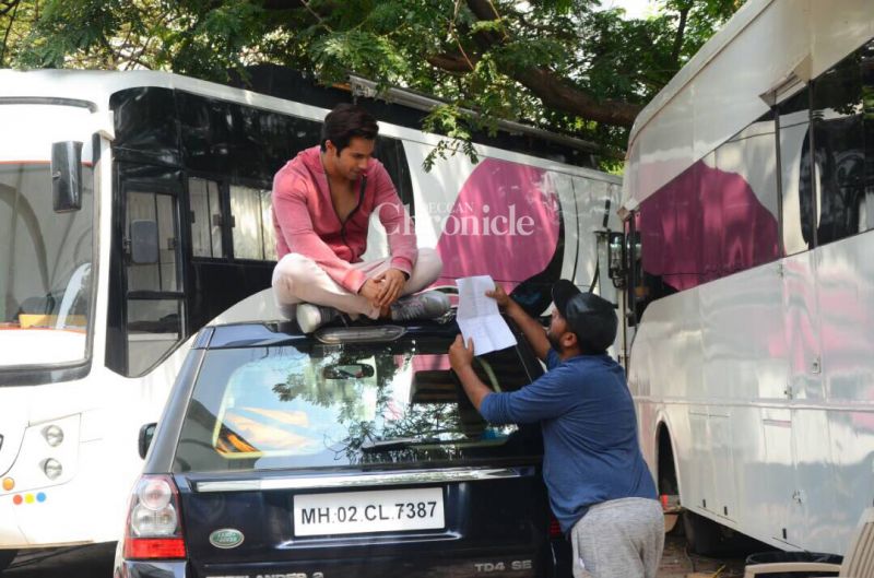 Varun Dhawan rehearses his lines on top of a car on Judwaa 2 sets
