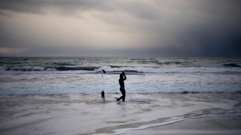 Fun time: Surfers enjoy, ride waves along Northern Atlantic Ocean