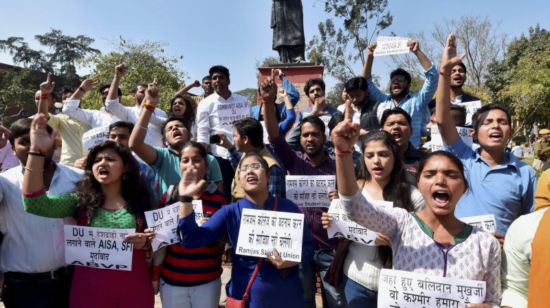 ABVP activists shout slogans as they hold a protest against AISA at DU campus in New Delhi. (Photo: PTI)