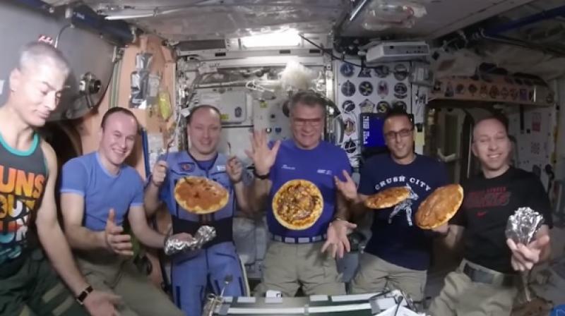 Astronauts make pizza in zero gravity. (Photo: Youtube screengrab)