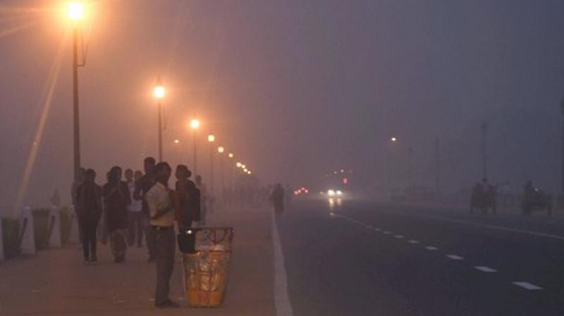 Vehicles ply on smog covered Rajpath in New Delhi on Saturday. (Photo: PTI)