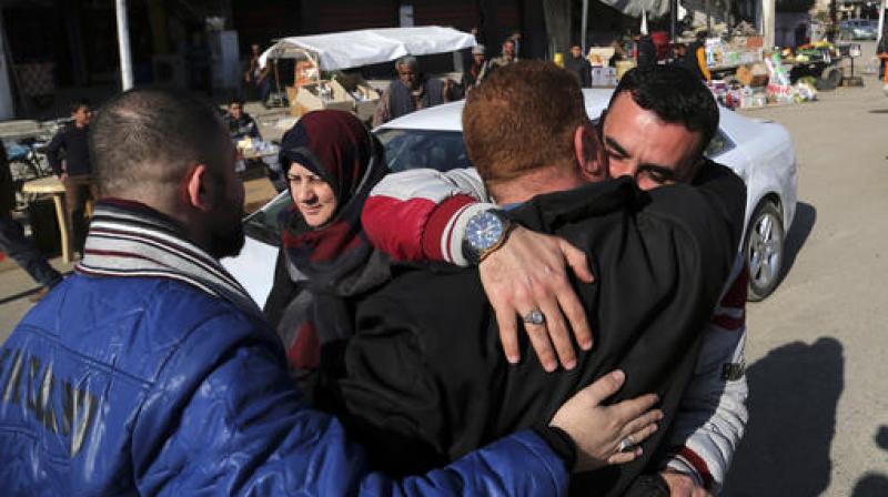Civilians congratulate each other after they survive the fight between Iraqi security forces and Islamic State militants in a neighborhood recently liberated from the militia on the eastern side of Mosul, Iraq. (Photo: AP)