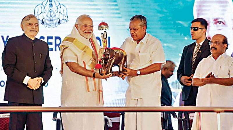 PM Narendra Modi being felicitated by Chief Minister Pinarayi Vijayan during an event to inaugurate the Kollam Bypass on NH 66, in Kollam district of Kerala on Tuesday. Governor P. Sathasivam looks on.