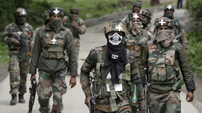 Army soldiers walk back towards their base camp after a search operation in Shopian. (Photo: AP)