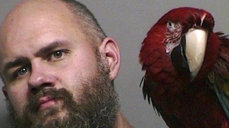 Man reunited with companion parrot in mug shot. (Photo: Washington County Sheriffs office)