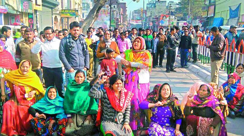 Kin of Chandan Gupta, along with local people, participate in a dharna in violence-hit Kasganj on Tuesday.  (Photo: PTI)