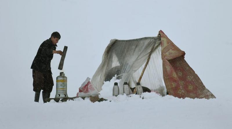 Afghan tea vendor Imran, 15, prepares tea for customers on a hillside during snowfall near Qargha Lake on the outskirts of Kabul on February 4, 2017. Avalanches after three days of heavy snow destroyed homes and killed over 20 people in central and northeastern provinces of the country. (Photo: AFP)