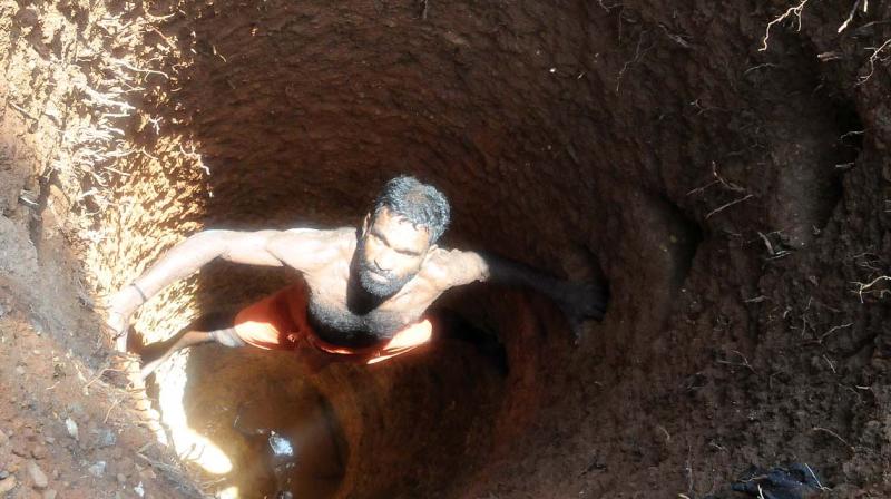 S. Ratheesh, a well-digger looks at one of the wells he recently dug at Jawahar Nagar in Thiruvananthapuram city (Photo: DC)