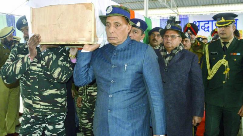 Union home minister Rajnath Singh shoulders the coffin of a slain CRPF jawan in Budgam on Friday. (Photo: PTI)