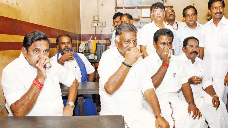Chief Minister Edappadi K. Palaniswami sipping tea at a shop in Thiruthuraipoondi, Thiruvarur district, on Wednesday during his visit to cyclone-affected areas. Deputy Chief Minister O. Panneerselvam, ministers Sellur K. Raju and R.B. Udhayakumar are also seen. (Photo: DC)