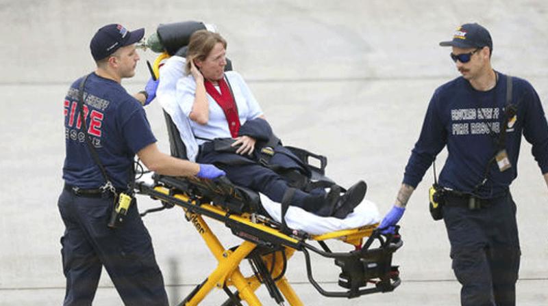 olice waiting to escort employees and passengers walking outside terminal 2 at the scene of a deadly shooting at Fort LauderdaleHollywood International Airport. (Photo: AP)